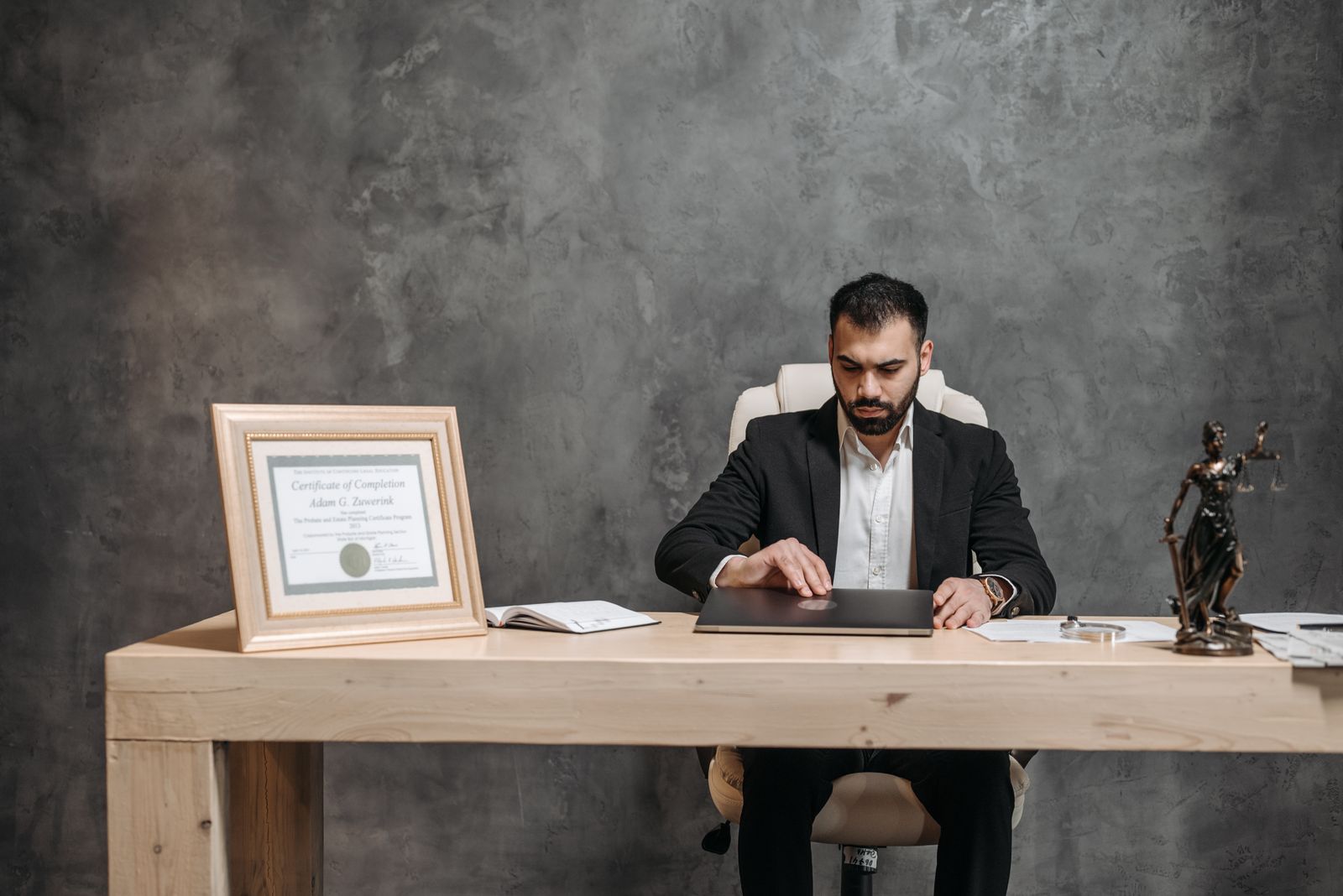 An attorney working at his desk in a dimly lit law office
